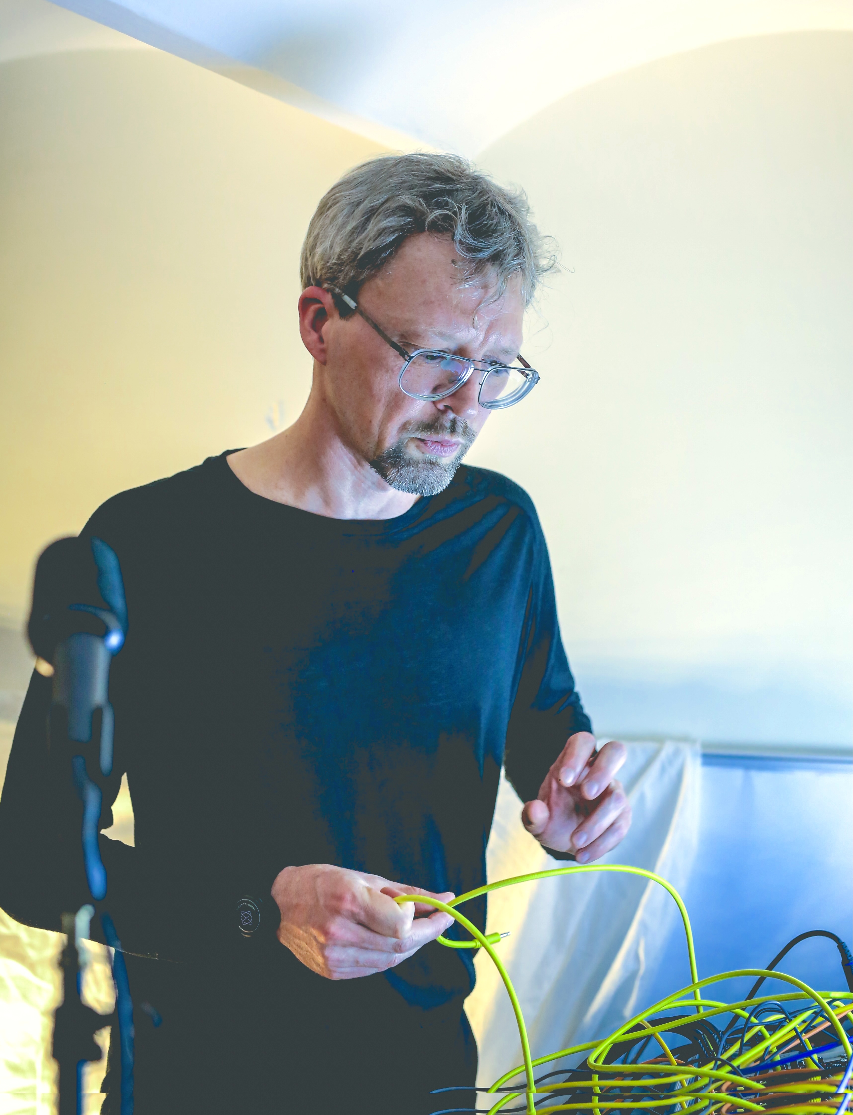 Ove Holmqvist patching cables during a performance setup