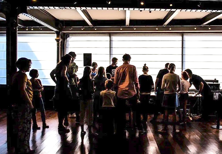 Workshop participants testing instruments in a museum setting